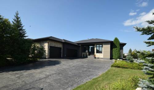 The sprawling bungalow at 8 Orchard Gate &mdash; situated on a gorgeous lakeside lot &mdash; offers over 4,400 sq. ft. of well-appointed living space.