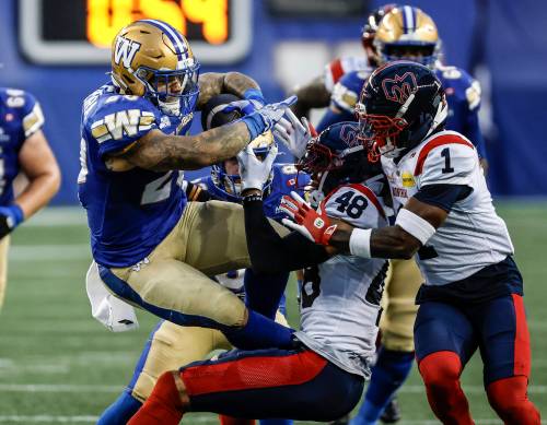 John Woods / THE CANADIAN PRESS
                                Winnipeg Blue Bombers&rsquo; Brady Oliveira rumbles for a first down as he&rsquo;s tackled by Montreal Alouettes&rsquo; Kabion Ento in the first half of the Bombers 44-28 win on Friday at Princess Auto Stadium.