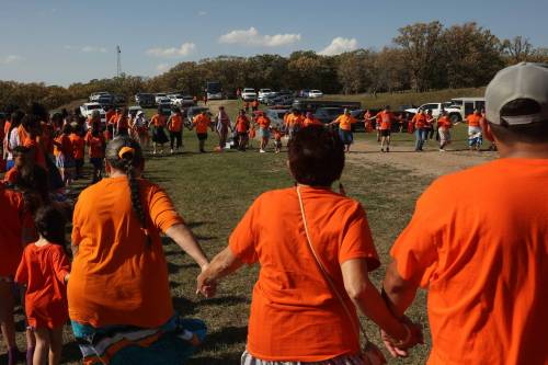 Participants take part in a round dance following an Orange Shirt Day Walk last September in Brandon. (Tim Smith / The Brandon Sun files)