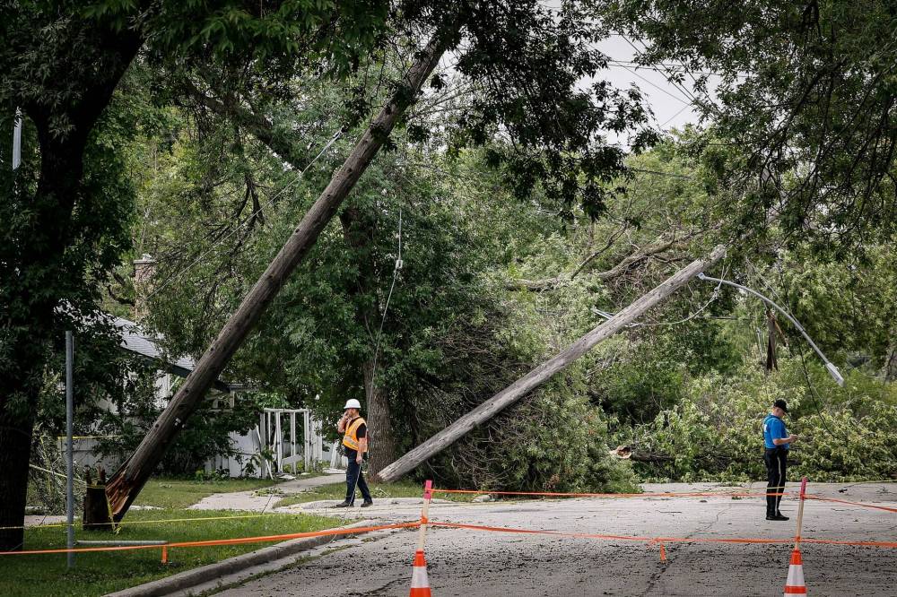 JOHN WOODS / FREE PRESS
                                Residents and crews clean up damage on Borebank Street Monday.
