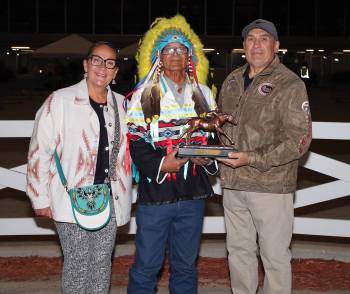 Jason Halstead / Assiniboia Photo
                                Chief Murray Clearsky (centre) presents the championship trophy to 2026 leading Assiniboia Downs trainer Jerry Gourneau, with his wife Lyn Blackburde.