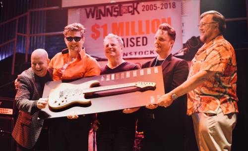 SUPPLIED
                                Al Jacks, right, presents the members of Britainy Speerz with the &ldquo;best band&rdquo; trophy at Winn$tock 2018. Winn$tock is a battle of the bands charity fundraiser featuring bands comprised of members of the financial and legal services communities. It returns Thursday evening after a seven-year hiatus.