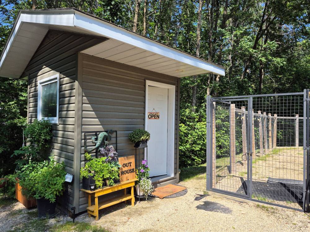 Colleen Zacharias / Free Press
                                The spacious rural property has all the amenities, including a modern outhouse and roomy kennel for the family pet.