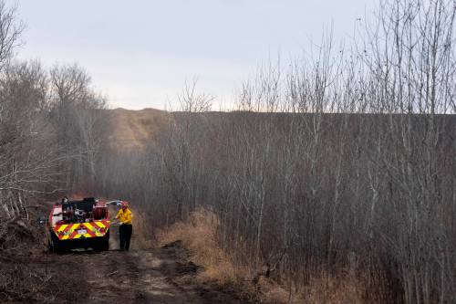 CHRISTOPHER KATSAROV / THE CANADIAN PRESS FILES
                                Firefighters work along a firewall next to CFB Wainwright, south of the town Wainwright, Alta., on Monday.