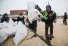 (John Woods / The Canadian Press files) Manitoba Premier Wab Kinew loads sandbags onto a trailer at Peguis First Nation, in April.