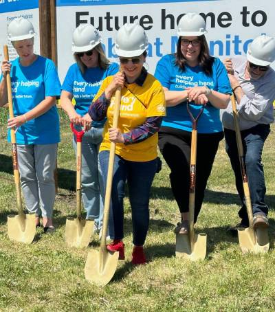 Habitat for Humanity
                                Ritchel Quezon (centre) pushes a shovel into the grass at the site of her future Habitat for Humanity home in Neepawa. Habitat helps dozens of local families each year reach homeownership.