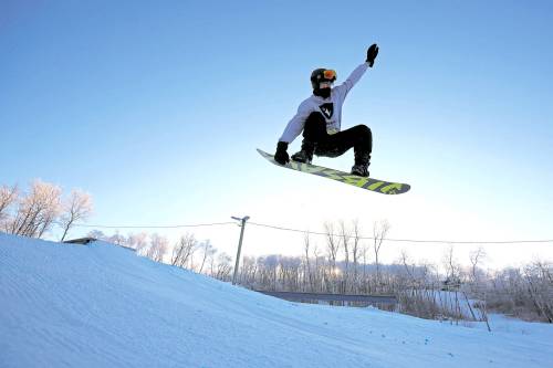 A snowboarder sails off a box in the terrain park at Asessippi Ski Resort in this file photo. The resort is expected to make an announcement about operational impacts due to flood damage by Nov. 6. (Tim Smith / The Brandon Sun files)