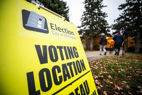 Voters enter the Strathmillan School polling station in Winnipeg on Wednesday. (Mikaela MacKenzie / Free Press)