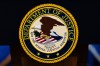 FILE - The U.S. Department of Justice logo is seen on a podium before a news conference, May 4, 2026, in Washington. (AP Photo/Julia Demaree Nikhinson, File)