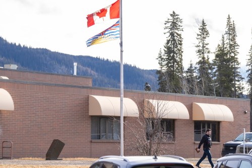 An RCMP officer walks out of the school where a mass shooting took place in Tumbler Ridge, B.C., on Thursday, Feb. 12, 2026. THE CANADIAN PRESS/Christinne Muschi