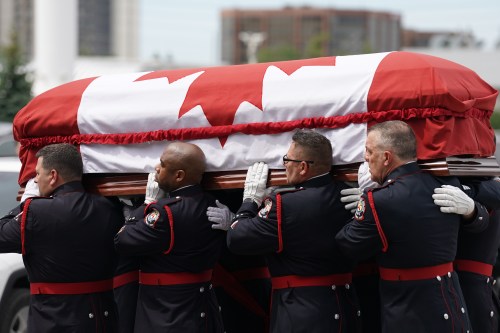 Police officers carry the casket in during the start of a funeral for Toronto Police Constable Marc Pinizzotto in Toronto, on Wednesday, June 24, 2026. THE CANADIAN PRESS/Arlyn McAdorey